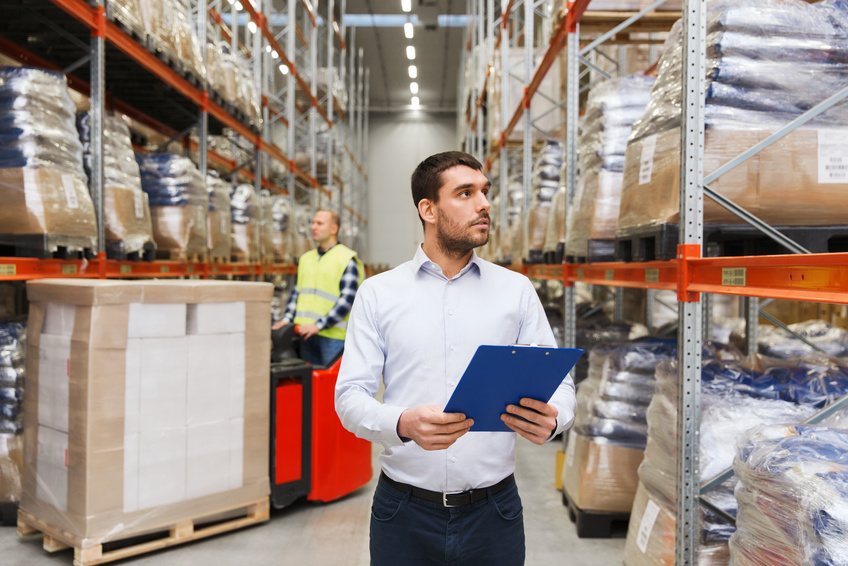 businessman with clipboard at warehouse personnel vérifiant le contenu de l'entrepôt
